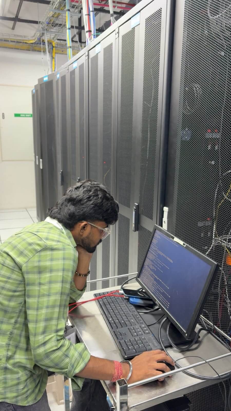 eWebGuru engineer configuring a dedicated server from a console beside the rack