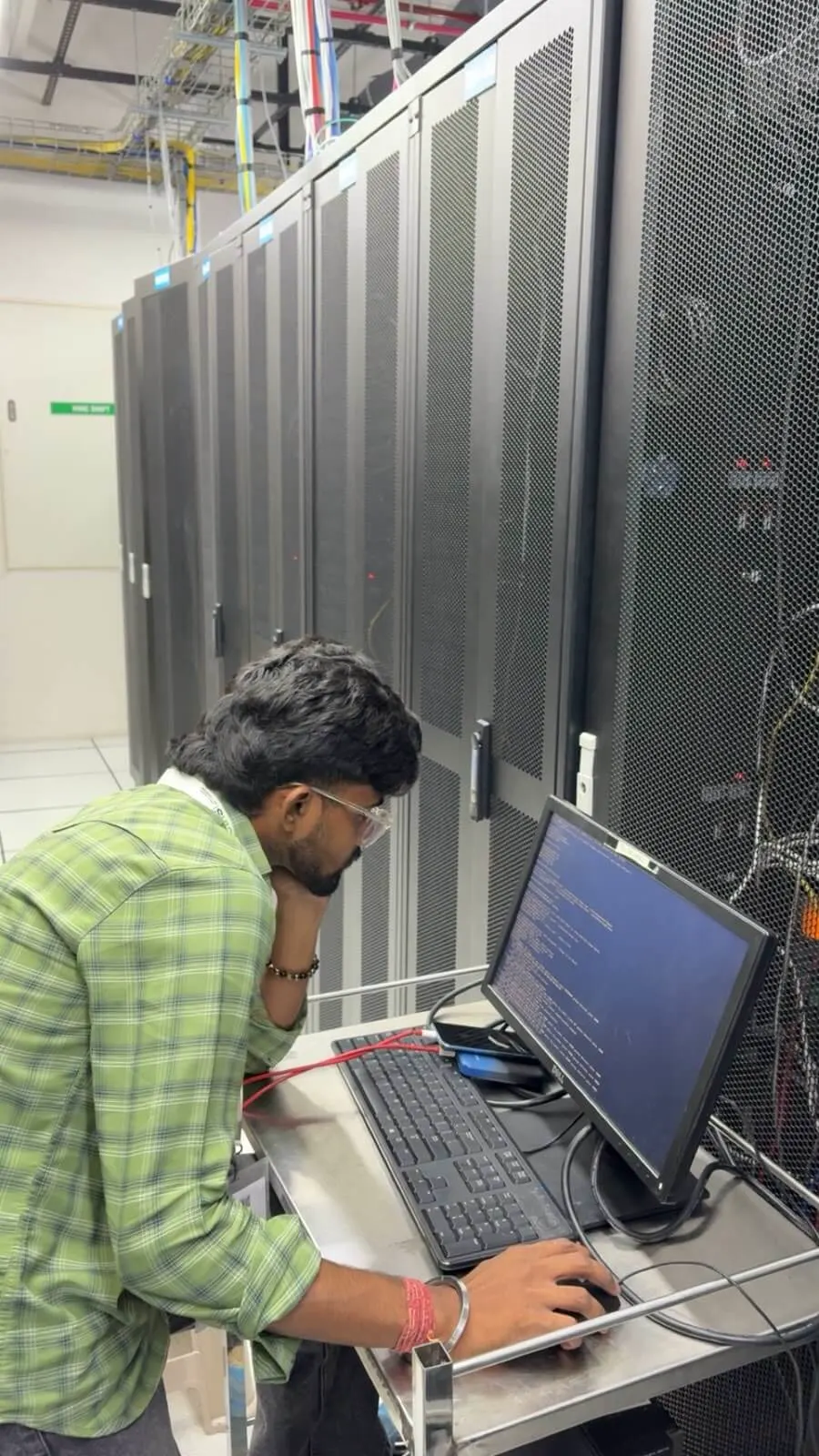 eWebGuru engineer running a server console session in front of racks at the datacenter